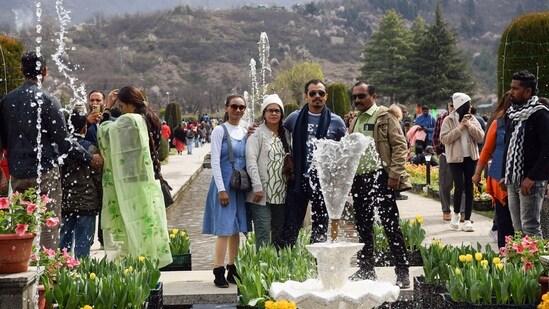 Tourists pose for a photo at Indira Gandhi Memorial Tulip Garden after it has been opened to the public, in Srinagar.(ANI)
