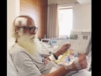 Sadhguru reading a newspaper inside the hospital. 