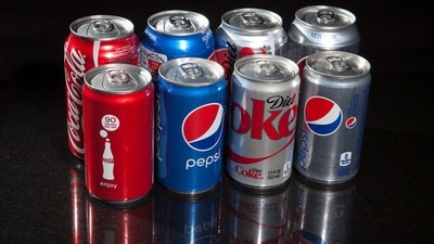 Regular and mini cans of Coke and Pepsi are pictured in this photo. Earlier in 2019, Coca-Cola’s consultants visited the fields and sugar mills and reported that children were cutting sugar cane. (Reuters)