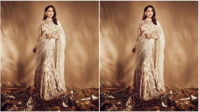 Her stunning outfit features a sweetheart neckline blouse with full sleeves and enchanting gold embellishments. She paired it with a matching flared skirt that exuded shimmer and glitter vibes. She completed her look with a matching ivory net dupatta. (Instagram/@madhuridixitnene) Her stunning outfit features a sweetheart neckline blouse with full sleeves and enchanting gold embellishments. She paired it with a matching flared skirt that exuded shimmer and glitter vibes. She completed her look with a matching ivory net dupatta. (Instagram/@madhuridixitnene)