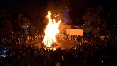 People perform Holika Dahan on the eve of the Holi festival, at Holi ground in Gurugram on Sunday. A bonfire is lit to celebrate the burning of the demoness, Holika. (ANI)