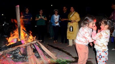 Children smear each other with colours during Holika Dahan on the eve of the Holi festival, at Model Town in Patiala on Sunday. (ANI)