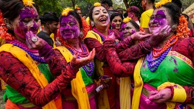 Women put coloured powder to each other as they celebrate Holi, the festival of colors, in Kolkata. (AP)