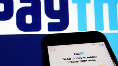 The interface of Indian payments app Paytm is seen in front of its logo displayed in this illustration picture. (Reuters)