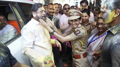 Maharashtra Chief Minister Eknath Shinde with police personnel during Holi celebrations at his residence, in Thane. (PTI)