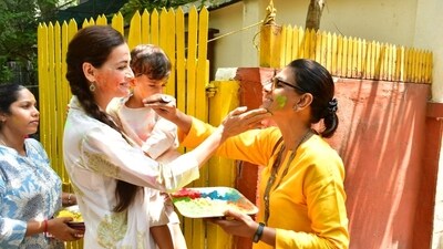 Dia Mirza carries son Avyaan Azaad in her arms as Nandita Das puts gulaal on her face. Dia was last seen in Dhak Dhak and Nandita directed Kapil Sharma in Zwigato. 