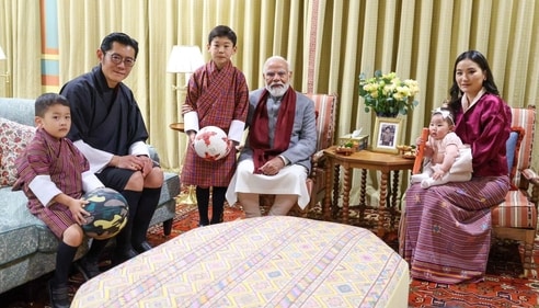 PM Modi interacting with the two young princes while Princess Sonam is seen in Queen Pema's lap. (ANI) PM Modi interacting with the two young princes while Princess Sonam is seen in Queen Pema's lap. (ANI)