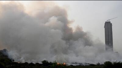 All horticulture waste from across Noida is dumped at that plot for conversion into compost. The guard who was on duty there on Monday evening said some two or three people had come there and set fire to the waste. They later fled the spot, he said. (Sunil Ghosh/HT Photo) All horticulture waste from across Noida is dumped at that plot for conversion into compost. The guard who was on duty there on Monday evening said some two or three people had come there and set fire to the waste. They later fled the spot, he said. (Sunil Ghosh/HT Photo)