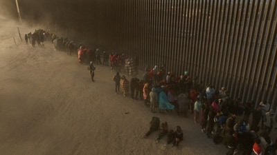 A drone view shows migrants enduring cold and blustery weather as they line up against the border wall to surrender to immigration officials after breaching a razor wire-laden fence along the bank of the Rio Grande River in El Paso, Texas, U.S., March 25, 2024. REUTERS/Adrees Latif (REUTERS)