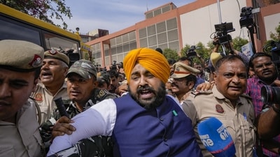 Security personnel detain Punjab minster and AAP leader Harjot Singh Bains during their protest outside Patel Chowk metro station against the arrest of Delhi CM Arvind Kejriwal. (PTI) Security personnel detain Punjab minster and AAP leader Harjot Singh Bains during their protest outside Patel Chowk metro station against the arrest of Delhi CM Arvind Kejriwal. (PTI)