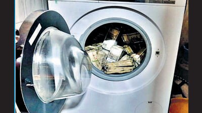 Part of the cash seized was found stashed in a washing machine. Part of the cash seized was found stashed in a washing machine.