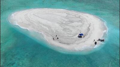 This handout photo shows Philippine scientists inspecting Sandy Cay reef, near the Philippine-held Thitu Island, in Spratly Islands, in the disputed South China Sea on March 22. The Philippine Coast Guard on March 22 accused a Chinese vessel of "dangerous manoeuvres" as it attempted to block Filipino scientists from reaching a reef in the South China Sea. (AFP FILE/Philippine Coast Guard) This handout photo shows Philippine scientists inspecting Sandy Cay reef, near the Philippine-held Thitu Island, in Spratly Islands, in the disputed South China Sea on March 22. The Philippine Coast Guard on March 22 accused a Chinese vessel of "dangerous manoeuvres" as it attempted to block Filipino scientists from reaching a reef in the South China Sea. (AFP FILE/Philippine Coast Guard)