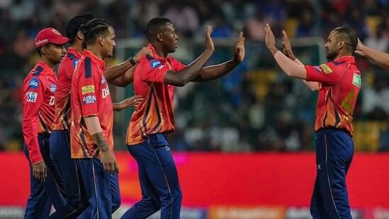 Punjab Kings' Kagiso Rabada with teammates celebrates the wicket of Royal Challengers Bengaluru batter Faf du Plessis (PTI)