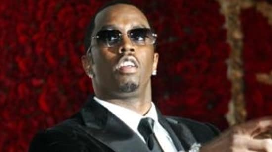 This November 4, 2004, file photo shows Sean ‘P. Diddy’ Combs directing photographers as they sing "Happy Birthday," to him as his date Kim Porter, left, listens, after Combs arrived for his 35th birthday celebration at Cipriani on Wall Street in New York. (AP)
