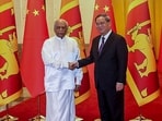 Sri Lanka's Prime Minister Dinesh Gunawardena (L) and China's Premier Li Qiang shake hands before their meeting in Beijing. 