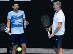 Serbia's Novak Djokovic, left, gestures as talks with coach Goran Ivanisevic during a practice session ahead of the Australian Open 