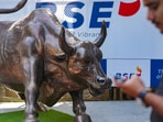 Stock market news: A man walks past the bull statue at BSE building in Mumbai.