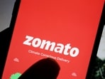 Zomato share price: The logo of Indian food delivery company Zomato is seen on its app on a mobile phone displayed in front of its company website in this illustration.