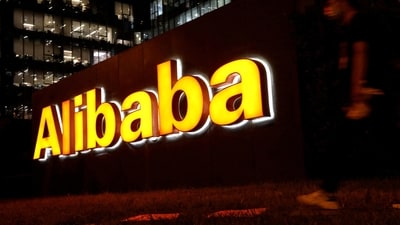 A man walks past Alibaba Group's logo at its office building in Beijing, China. (Reuters)