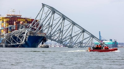 Members of the US Coast Guard patrol near the cargo ship Dali as it sits in the water after running into and collapsing the Francis Scott Key Bridge on March 26 in Baltimore, Maryland. (Getty Images via AFP) Members of the US Coast Guard patrol near the cargo ship Dali as it sits in the water after running into and collapsing the Francis Scott Key Bridge on March 26 in Baltimore, Maryland. (Getty Images via AFP)