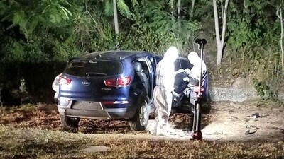 Law enforcement officials work at the scene where Ecuador's youngest mayor, Brigitte Garcia, was found shot dead in a car, according to the police, near San Vicente, Ecuador, in this handout image released on March 24, 2024. (via REUTERS)