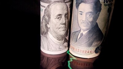 Japanese yen and US dollar banknotes are seen with a currency exchange rate graph in this illustration. (Reuters)