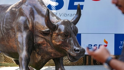 Stock market news: A man walks past the bull statue at BSE building in Mumbai. (PTI) Stock market news: A man walks past the bull statue at BSE building in Mumbai. (PTI)
