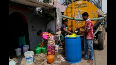 Residents of Ambedkar Nagar collect potable water from a private tanker in Bengaluru amid a severe water crisis in the city. (AP)