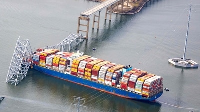 Baltimore Bridge Live Updates: In an aerial view, the cargo ship Dali sits in the water after running into and collapsing the Francis Scott Key Bridge on March 26, 2024 in Baltimore, Maryland.