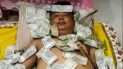 This photo of Assam politician Benjamin Basumatary with notes of ₹500 strewn all over his body went viral. This photo of Assam politician Benjamin Basumatary with notes of ₹500 strewn all over his body went viral.
