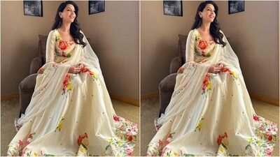 Nora Fatehi's outfit is from the shelves of designer Rohit Bal and features an ivory anarkali ensemble with a square neckline, full sleeves, flared bottoms and an enchanting multicoloured floral print that adorns the entire dress giving it a chic vibe. (Instagram/@norafatehi) Nora Fatehi's outfit is from the shelves of designer Rohit Bal and features an ivory anarkali ensemble with a square neckline, full sleeves, flared bottoms and an enchanting multicoloured floral print that adorns the entire dress giving it a chic vibe. (Instagram/@norafatehi)
