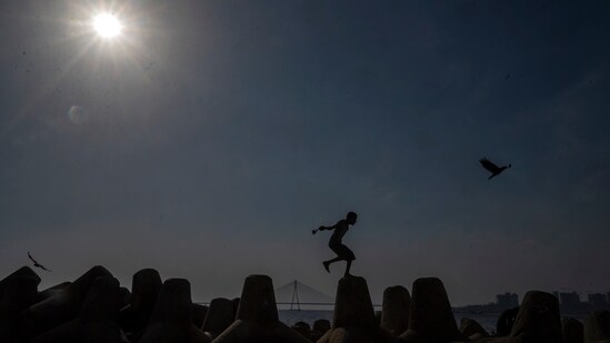 Mumbai, India - March 20, 2024: A boy Jumping in the afternoon heat as temperature soars at Dadar chowpatty in Mumbai, India, on Wednesday, March 20, 2024. (Photo by Satish Bate/ Hindustan Times) (Hindustan Times)