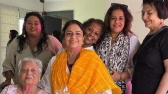 Priyanka's mother Madhu Chopra, a gynaecologist and who runs her production house Purple Pebble Pictures with her, was sene wearing a white kurta and a leheriya yellow dupatta. She posed with her friends and family at the Holi celebration in Noida.(Instagram)