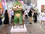 A visitor takes photos of works by Japanese artist Kaikai Keikei at Art Basel in Hong Kong. Hong Kong welcomes back Art Basel with 242 international galleries 