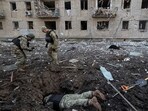 Police experts work at the site where buildings were damaged by a Russian military strike, amid Russia's attack on Ukraine, in Kharkiv, Ukraine 