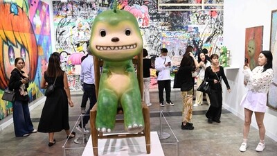 A visitor takes photos of works by Japanese artist Kaikai Keikei at Art Basel in Hong Kong. Hong Kong welcomes back Art Basel with 242 international galleries (Photo by Peter PARKS / AFP) A visitor takes photos of works by Japanese artist Kaikai Keikei at Art Basel in Hong Kong. Hong Kong welcomes back Art Basel with 242 international galleries (Photo by Peter PARKS / AFP)