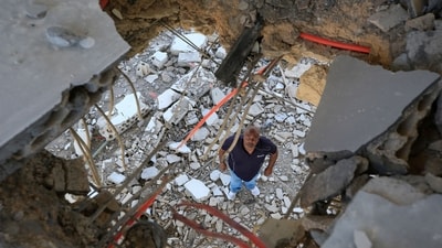 A man inspects the damage in his house in the southern Lebanese village of Marwahin, close to the southern Lebanese border with Israel on November 24, 2023. Since the Gaza war erupted on October 7, Lebanon's southern border with Israel has witnessed deadly exchanges of fire, primarily involving the Israeli army and Lebanon's Hezbollah movement, as well as Palestinian militant groups. (Photo by AFP) (AFP)