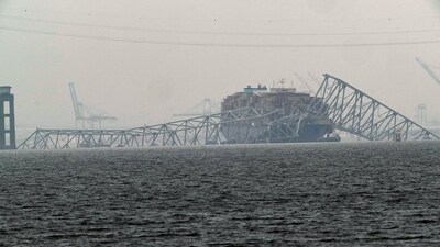 A container ship rests against the wreckage of the Francis Scott Key Bridge (AP)