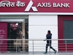 A man walks outside a branch of Axis Bank. The official said that the impacted customers are a small fraction of the overall spends and that "we are speaking about thousands and lakhs".