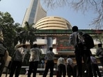  Stock market holiday: People look at a screen displaying the Sensex results on the facade of the Bombay Stock Exchange (BSE) building in Mumbai. Trading will remain closed on March 29 at the BSE and NSE.