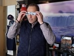 Niagara Falls, Ontario Mayor Jim Diodati, who says the city is preparing to host more than one million visitors during the upcoming April 8 solar eclipse event, poses with a pair of safety glasses at his office in Niagara Falls, Ontario, Canada. Solar eclipse fever grips Niagara Falls: Hotel and vintage train prices soar, party spots prepare for massive crowds 