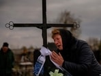 A mother laments over the grave of her son in Bucha, Ukraine	