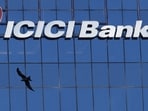ICICI Bank Credit Card rules: A bird flies past the facade of the ICICI bank head office in Mumbai, India. ICICI Bank will implement changes to airport lounge access benefits for 21 credit cards from April 1.