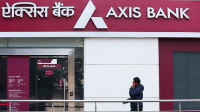 A man walks outside a branch of Axis Bank. The official said that the impacted customers are a small fraction of the overall spends and that "we are speaking about thousands and lakhs". (Reuters)