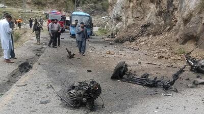 Police officers examine the site of suicide bombing at a highway in Shangla, district in the Pakistan's Khyber Pakhtunkhwa province, on Tuesday. (AP)