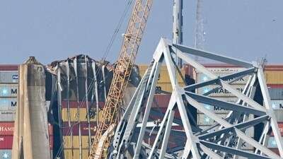 A crane begins clean-up at the collapsed Francis Scott Key Bridge after it was struck by the container ship Dali, in Baltimore, Maryland, on March 29, 2024. (Photo by Mandel NGAN / AFP) (AFP) A crane begins clean-up at the collapsed Francis Scott Key Bridge after it was struck by the container ship Dali, in Baltimore, Maryland, on March 29, 2024. (Photo by Mandel NGAN / AFP) (AFP)
