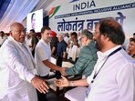 Congress President Mallikarjun Kharge and party leader Rahul Gandhi meet DMK MP Tiruchi N. Siva and others during the INDIA alliance rally at Ramlila Maidan in New Delhi on Sunday. (ANI Photo) Congress President Mallikarjun Kharge and party leader Rahul Gandhi meet DMK MP Tiruchi N. Siva and others during the INDIA alliance rally at Ramlila Maidan in New Delhi on Sunday. (ANI Photo)