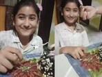 Snapshot of the young girl while she was cutting the cake. 