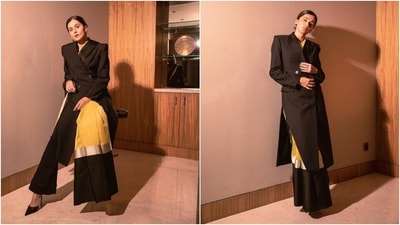 Coming to Taapsee's outfit, the overcoat features notch lapel collars, side slits, padded shoulders, and a tailored fitting. She wore the yellow-black saree by pleating it in the front and placing the pallu on the shoulder. Meanwhile, the pants feature a high-rise waist, a fitted silhouette on the thighs, and a flared hem. (Instagram) Coming to Taapsee's outfit, the overcoat features notch lapel collars, side slits, padded shoulders, and a tailored fitting. She wore the yellow-black saree by pleating it in the front and placing the pallu on the shoulder. Meanwhile, the pants feature a high-rise waist, a fitted silhouette on the thighs, and a flared hem. (Instagram)