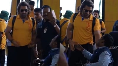 MS Dhoni greets a fan. MS Dhoni greets a fan.